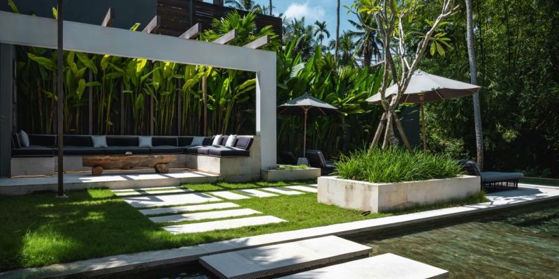 Modern poolside setting with integrated seating, colorful cushions, and a serene atmosphere